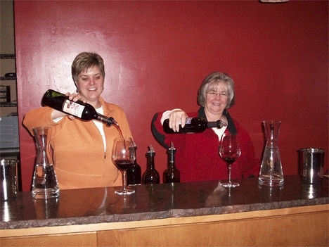 Laurel Davis and Linda Shafer pour a glass of wine at the new 2nd Street Wine Shop and tasting room that they recently opened.