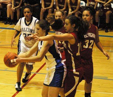 Falcon Lacy Williams does her best  to fend off a swarm of Red Raiders