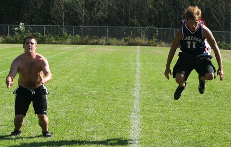 Falcon football players Danen Hagglund and Jordan Dibble demonstrate their jumping techniques as part of a series of drills on the first day of practice Wednesday.