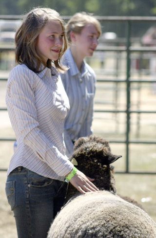 Maria Leese of Greenbank smiles as her sheep is named reserve grand champion in the 'natural colored