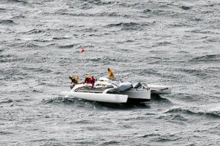 Boaters aboard a demasted catamaran drift near Cultus Bay on Saturday after high winds disabled their vessel.