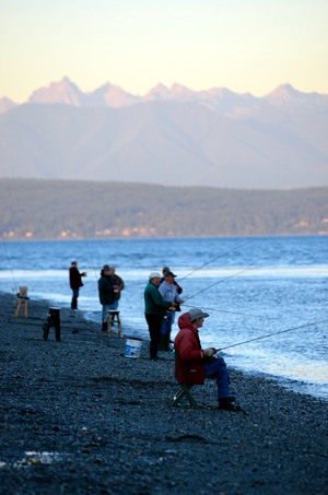 Coho fisherman line the beach at Bush Point Friday morning. Anglers will participate in the annual Whidbey Island salmon derby Sept. 13.