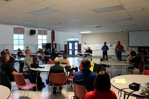 Representatives of Whidbey Telecom educate attendees on security and alarm systems at a property crime meeting May 19 in the South Whidbey High School  commons.