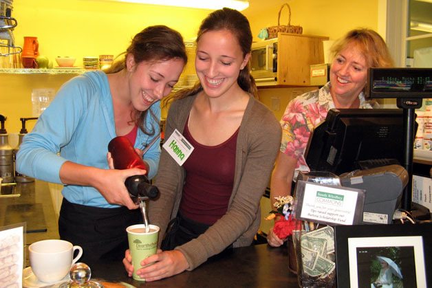 Haley and Hanna Herrin put the finishing touches on a specialty coffee while their mom Julie watches at the South Whidbey Commons.