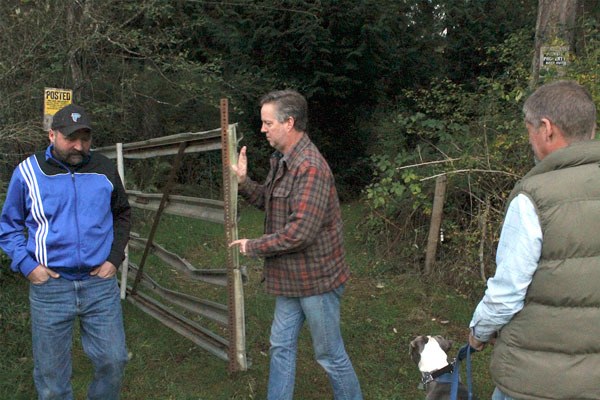 South Whidbey Parks and Recreation District commissioners Joel Gerlach and Mark Helpenstell (right) step aside as parks Director Doug Coutts opens a gate to the district’s new property during a tour. The 30-acre parcel