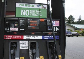 New pull-the-plug anti-PUD signs like these mounted atop gas pumps at the Bayview Exxon have popped up across the island this week.