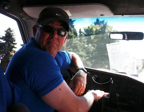 Island Transit driver Mark Vance counts the riders boarding his bus on Thursday at a downtown Langley bus stop.