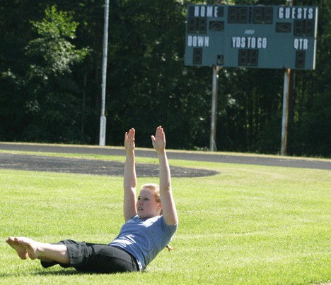 Kate Watters stretches on Monday at Waterman Field. Watters