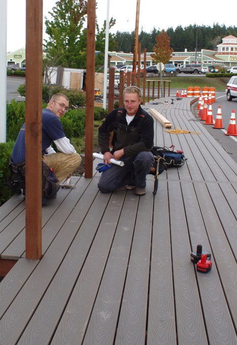 Ian Claypool and Leroy Boren work on the 120-foot boardwalk along Main Street in downtown Freeland.