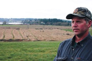 Ray Gabelein stands on hillside property owned by his family overlooking 54 acres of bottomland