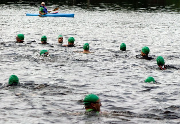 Racers wait in the chilly waters of Goss Lake at the start of the 2011 Whidbey Triathlon. More than 200 individuals competed in the 23.8-mile course that begins at the lake and finishes at Community Park.