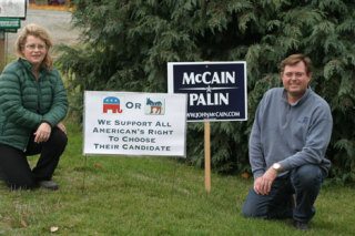Carol Griswold and Richard Bacigalupi pose next to the sign outside their Langley home that endorses freedom of choice when picking a presidential candidate. The couple  supports the Republican presidential ticket in Tuesday’s election.