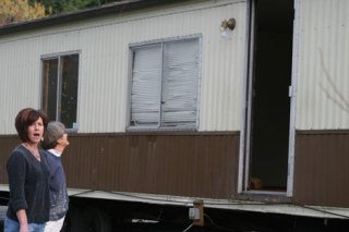 Goosefoot Community Fund's Debbie Torget and artist Mary Ann Mansfield react to what appeared to be a derelict manufactured home that someone dumped on Goosefoot property early Thursday morning.