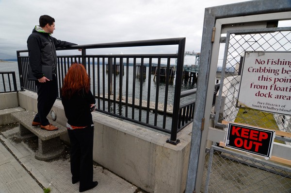 Byron Haley and Margaret Schwertner of the engineering firm Moffatt & Nichol look at the Clinton Beach Dock. The firm is one three the Port of South Whidbey is considering to fix the dock