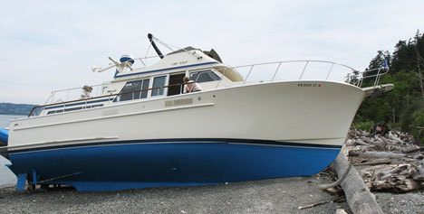 The cabin cruiser On Tap sits high and dry Tuesday south of Clinton after the people onboard fell asleep and their autopilot malfunctioned.