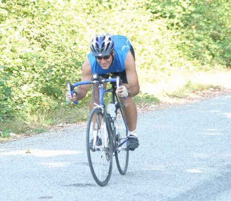 Matthew Swett road tests his racer Thursday as he trains for today’sbig Whidbey Island Triathlon.