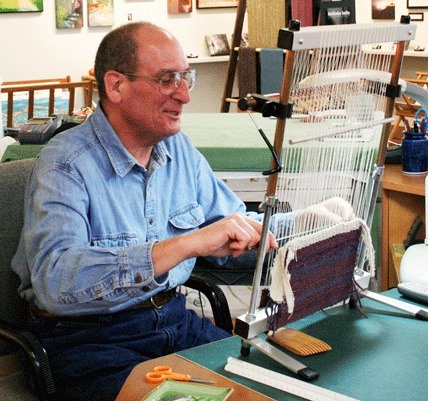 Windwalker Taibi works at his loom at his Raven Rocks Studio and Gallery in Greenbank.