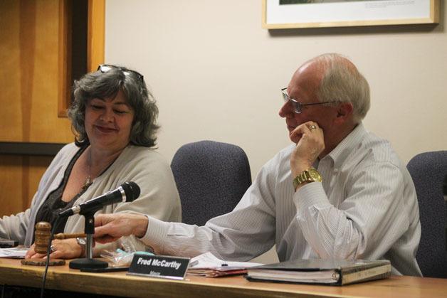 Debbie Mahler smiles as Mayor Fred McCarthy swings the gavel to conclude the Dec. 21 city council meeting