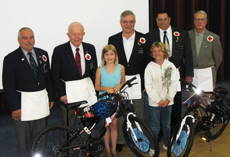 The givers and the winners of the Books for Bikes at South Whidbey Elementary School this week. Third-graders Gwen Ramsay and Owen Miller are joined by Langley Masons Jim Fulton