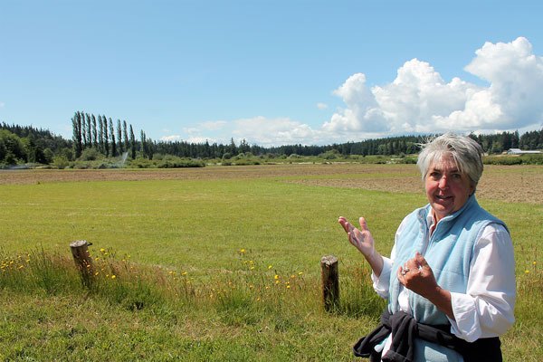 Organic Farm School Executive Director Judy Feldman stands on the site that will house the school.