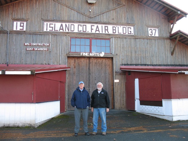 Local historians Bob Waterman and Harrison Goodall pose in front of the Pole Building