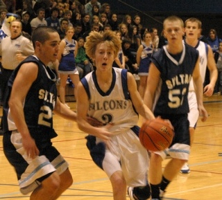 Falcon Riley Newman powers his way past a couple of Sultan Turks on Friday. South Whidbey lost