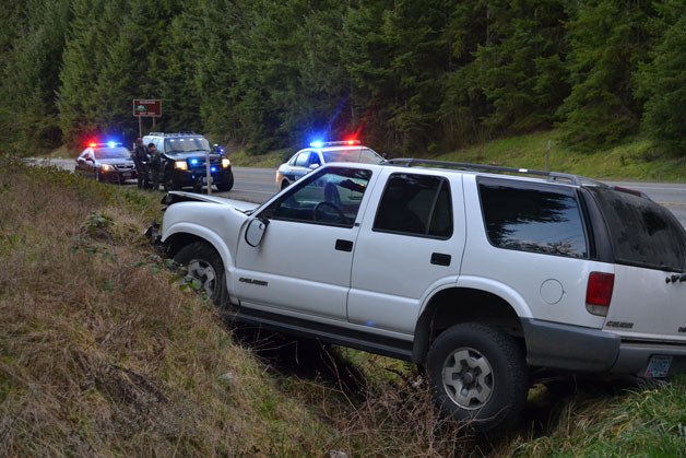 A white Chevrolet Blazer heading northbound on Highway 525 took a turn too late on Midvale Road and crashed into the hillside.