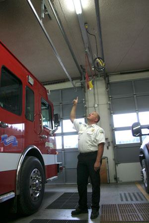 Deputy Chief Jon Beck points to some roof damage and sagging bay doors at the Bayview fire station.
