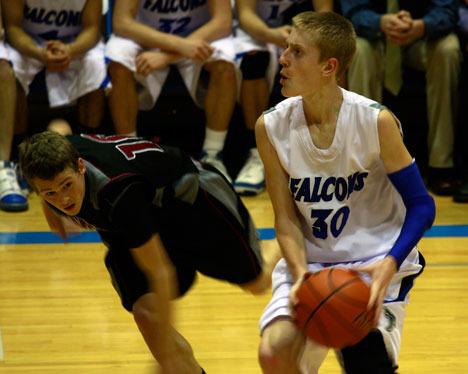 Falcon leading scorer Riley Newman looks for his shot against a swarming Cedarcrest defender. South Whidbey beat the Cascade’s top 2A team in dramatic fashion earlier this week.