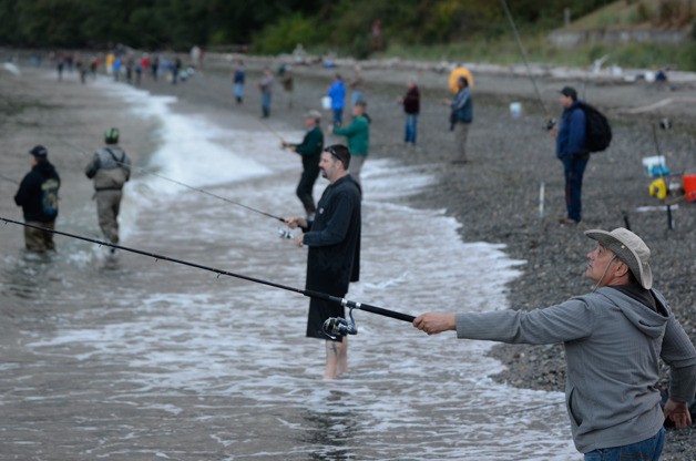 A fisherman who declined to provide his name tosses a cast Friday morning at Bush Point. The area has seen several assaults this month from quarreling anglers.