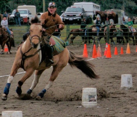 Cameron Dahl slaloms through some buckets for a first- place finish at a recent Western Games competition at Island County Fairgrounds in Langley.