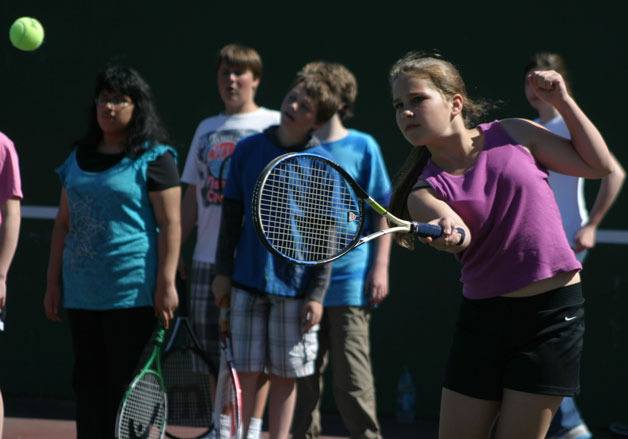 Tiegan Dussault works on groundstrokes during the parks district’s junior tennis team practice Thursday.