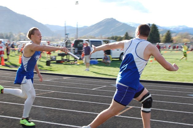 Kale Reichersamer hands off to Nick French in the mile relay at the Cashmere Invitational on Saturday