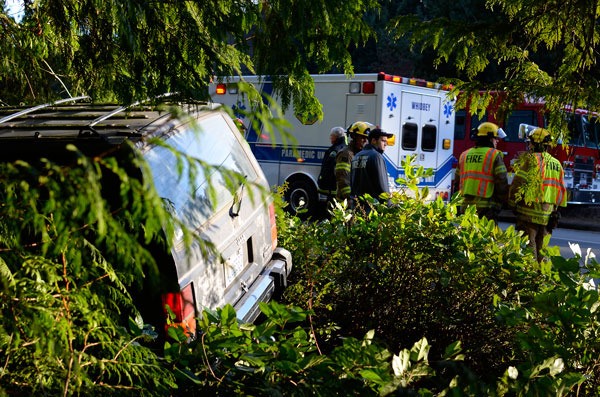 South Whidbey Fire/EMS officials talk after a one-car crash on Bayview Road Thursday.