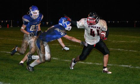 Coupeville’s Dalton Engle tries unsuccessfully to avoid South Whidbey’s Jon Poolman and Tyler “Chuck” Norris.