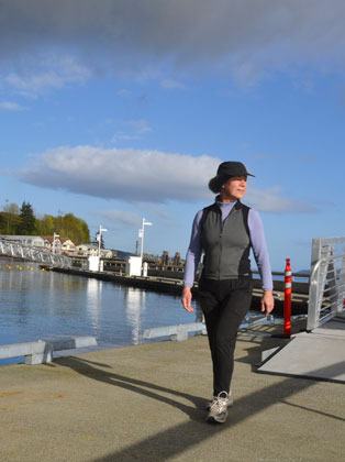 Langley resident Marie Lincoln takes a morning walk on the new docks at South Whidbey Harbor. The project is nearly complete and the Port of South Whidbey is planning a grand opening next week.