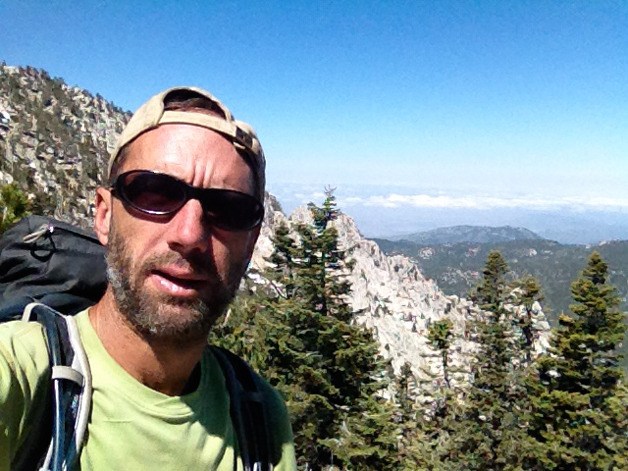 Brad Hankins stops for a quick self-portrait with the majestic Pacific Crest Trail behind him.