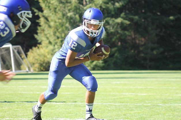 South Whidbey sophomore Wesley Crain prepares to hand off the ball to a running back at practice.