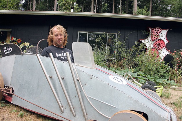 Tim Leonard inspects the driver’s seat of his Soup Box Derby racer