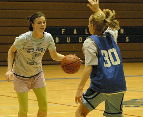 Falcon Emily Martin attempts to break away from defending teammate Hayley Newman during the first day of girls basketball practice at South Whidbey High School.