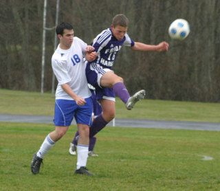 Falcon Jeff Brasko and Wolverine Tyler Roberts tango in the rain Saturday during South Whidbey’s lopsided 9-0 soccer victory over Friday Harbor.