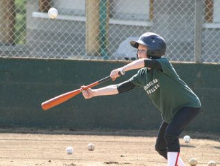 Little Leaguer Will Simms perfects his bunting style Monday during a drill session at South Whidbey’s Community Park. Responding to the current budget crisis