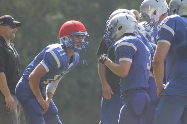 Senior quarterback Charlie Patterson calls a play from the huddle during practice.