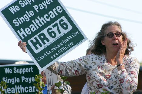 Kris NerisonCollins shouts to travelers on Highway 525 during Wednesday’s protest over healthcare reform in Bayview. The demonstration attracted a crowd of roughly 60 from across South Whidbey and beyond.