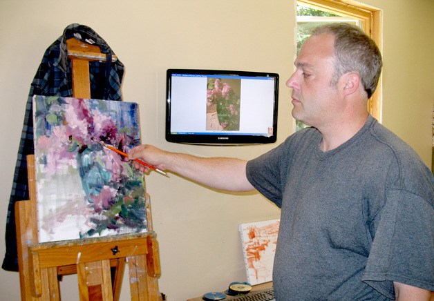 Oil painter Mike Wise works from a photograph he took of lilacs grown on his property near Fort Ebey State Park.