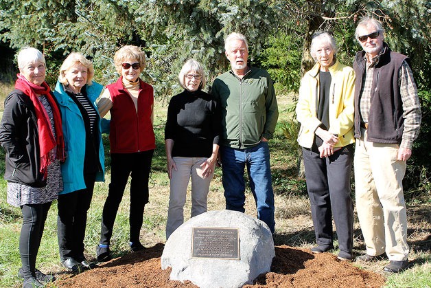 Evan Thompson / The Record South Whidbey community members recently gathered to celebrate the installation of a plaque and boulder that commemorates the six-year effort of a group that prevented Saratoga Woods from being developed into a 200-room resort. From left to right: Sharon Emerson