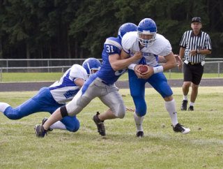 Falcon quarterback Hunter Rawls is sacked behind the line during Saturday’s blue-and-white scrimmage.