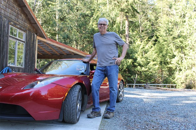 Tim Economu stands next to his Tesla Roadster outside his Clinton home. Economu organized an electric vehicle show on April 23 at the Bayview Cash Store as part of Whidbey Earth and Ocean Month’s Earth Day Festival. He hopes it will be the biggest electric vehicle show on Whidbey Island.