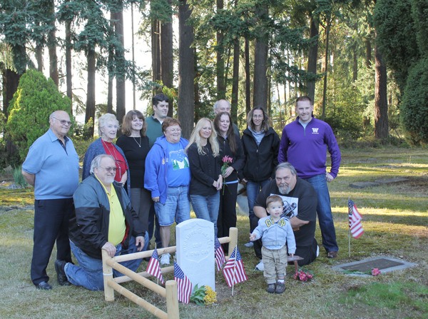Members of the Newell family stand near the graves of their ancestors. Warren Newell