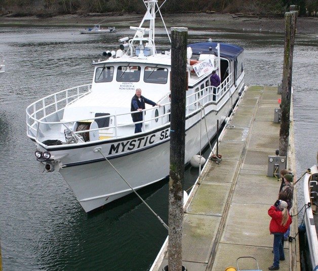 Standing on the bow is owner and Capt. Monte Hughes. Harbormaster Julie James greeted the boat’s arrival.